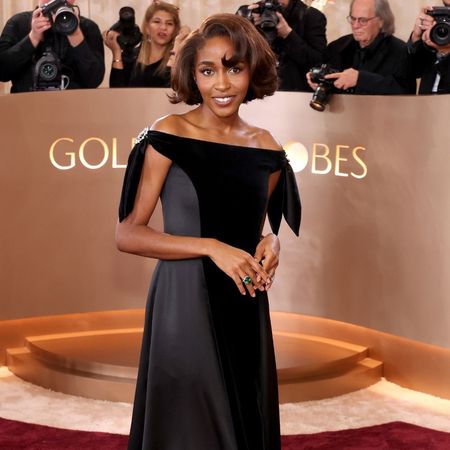 Ayo Edebiri wears a Chanel black satin and velvet dress to the Golden Globes 2026