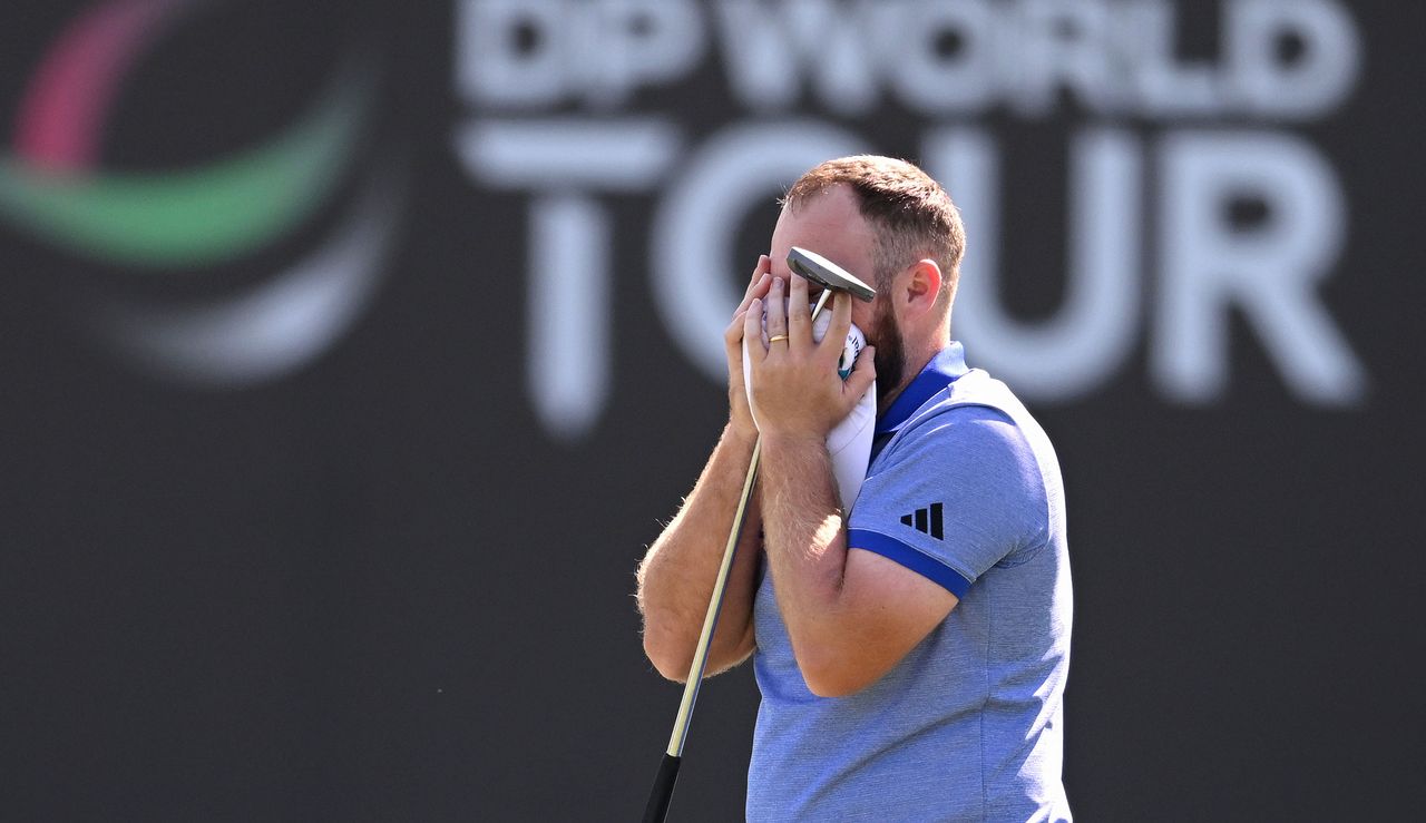 Hatton puts his head in his hands after holing an eagle putt