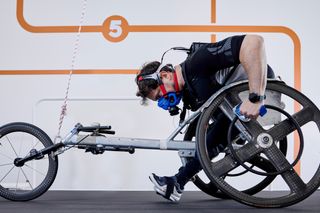 Man wheelchair cycling on multi-functional treadmill