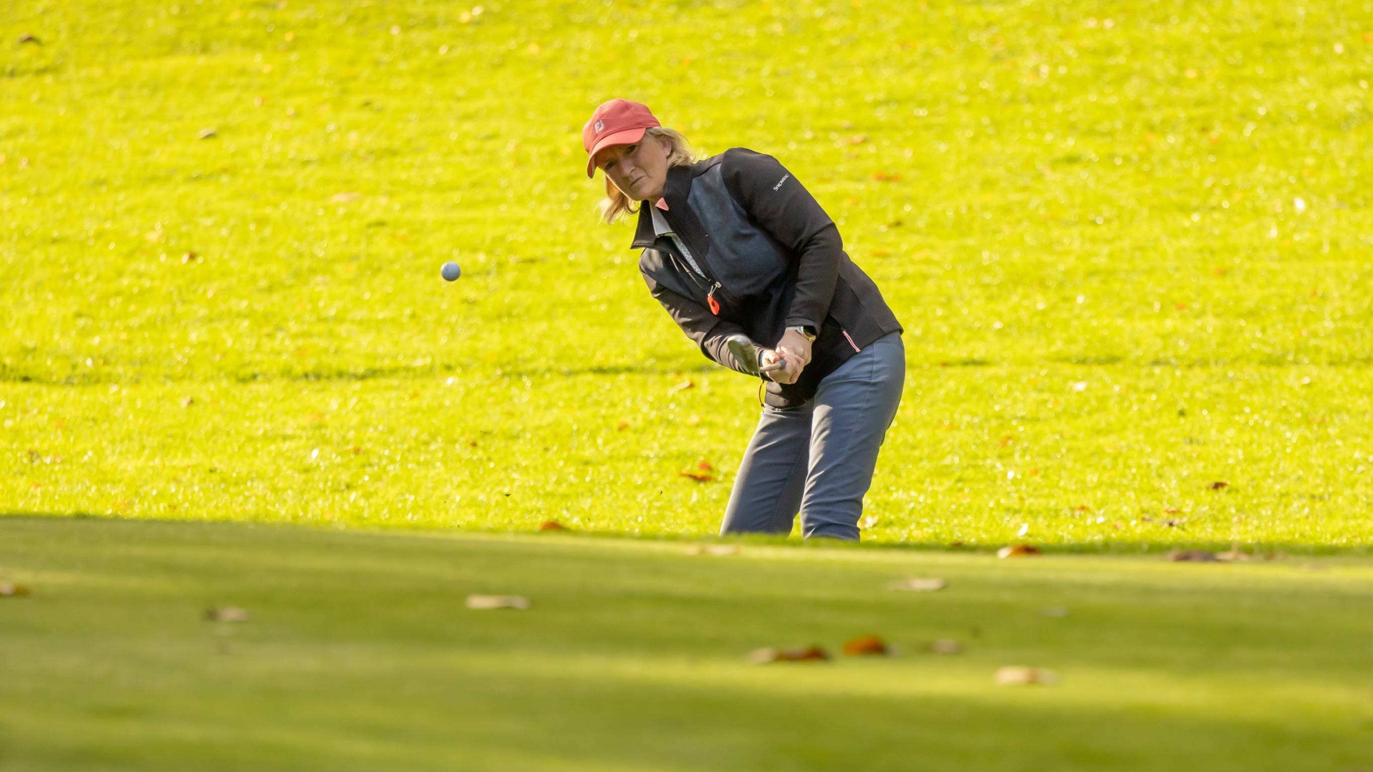 Female golfer playing a chip shot