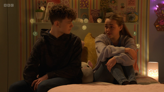 Amy Mitchell and Ricky Jr sit on Amy's bed. Amy cries as she talks about her mum Roxy