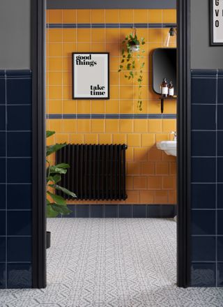 mustard tiles and grey tiles in a contemporary bathroom with monochrome accessories