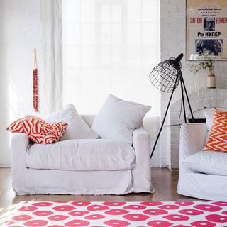 white sofa with red floor rug