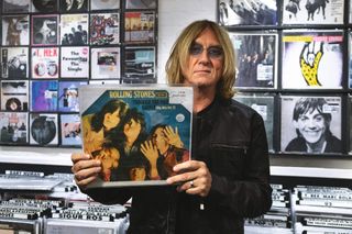 Joe Elliott with a copy of The Rolling Stones' Through The Past, Darkly