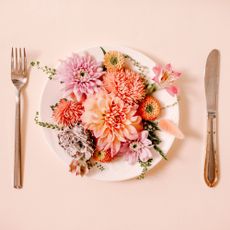 Plate of edible flowers with knife and fork