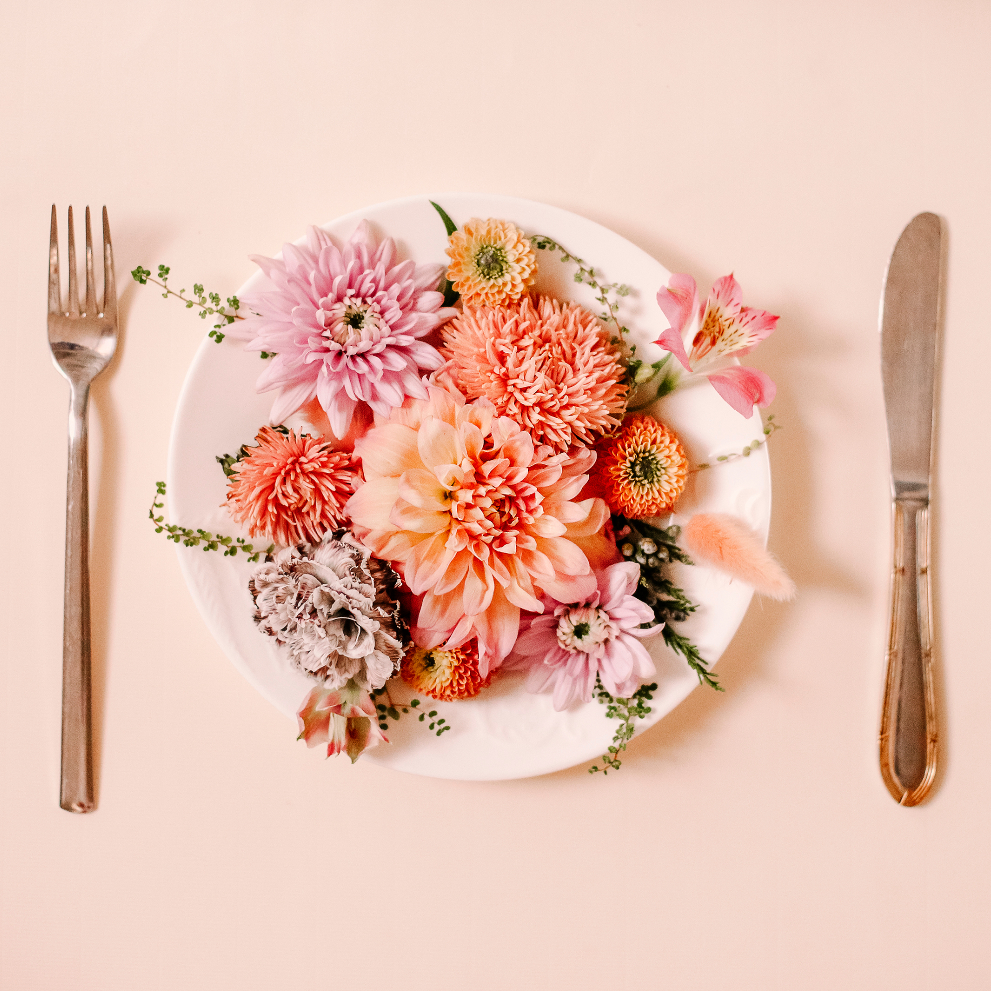 Plate of edible flowers with knife and fork