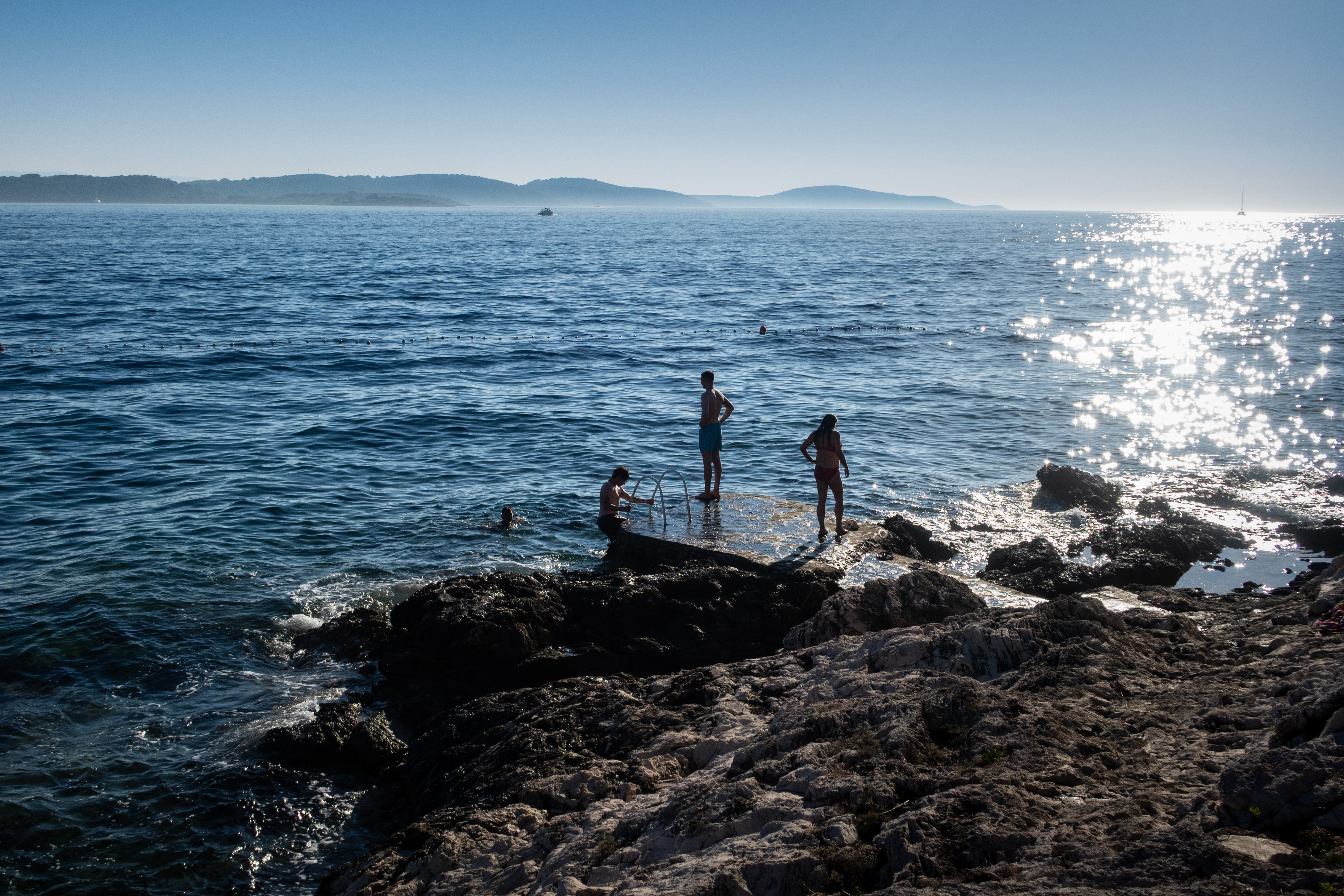 People look out at the water in Hvar, Croatia