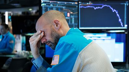 Trader with stock chart behind © Spencer Platt/Spencer Platt via Getty Images