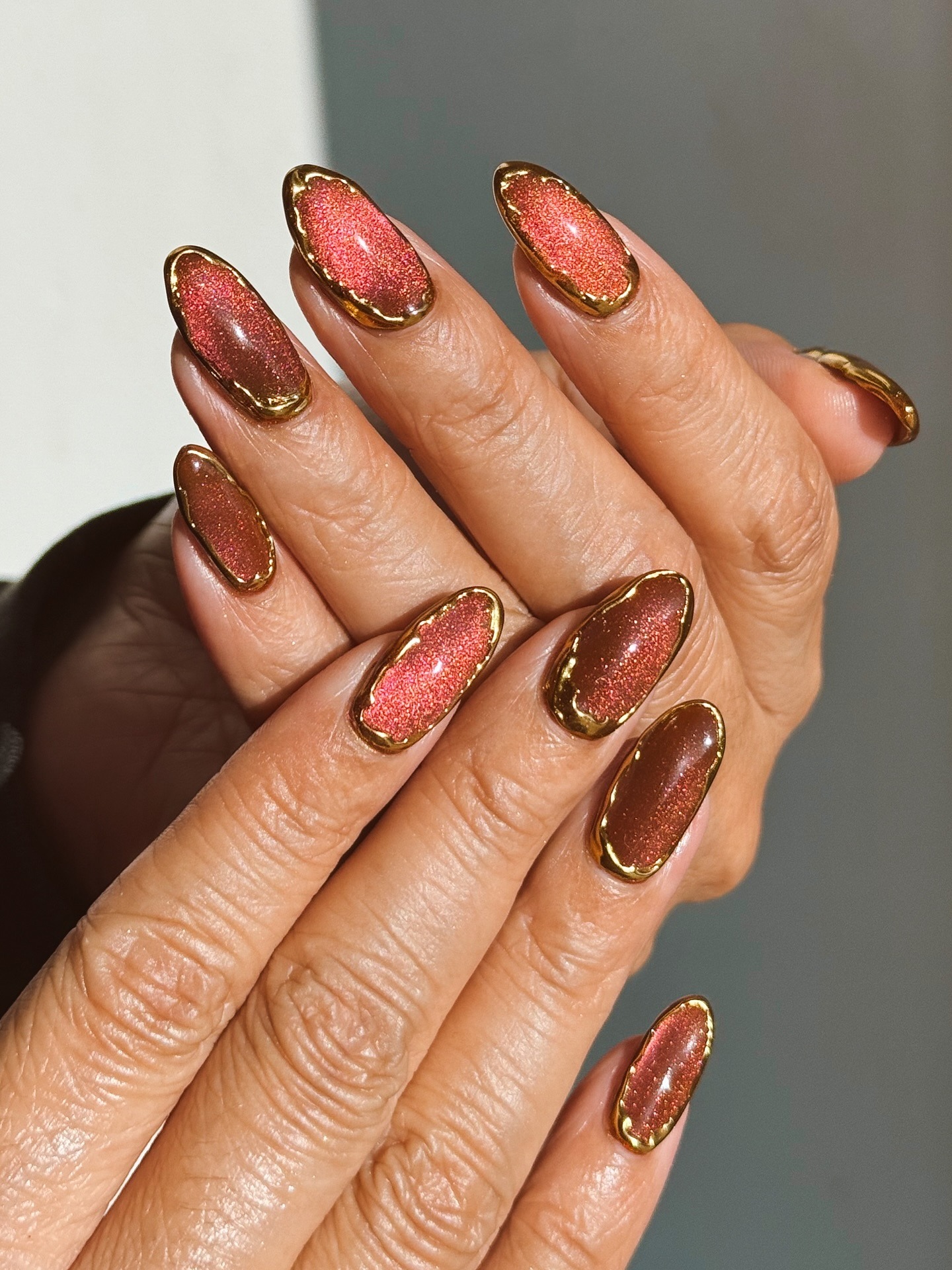 Copper velvet nails with gold 3D accents.