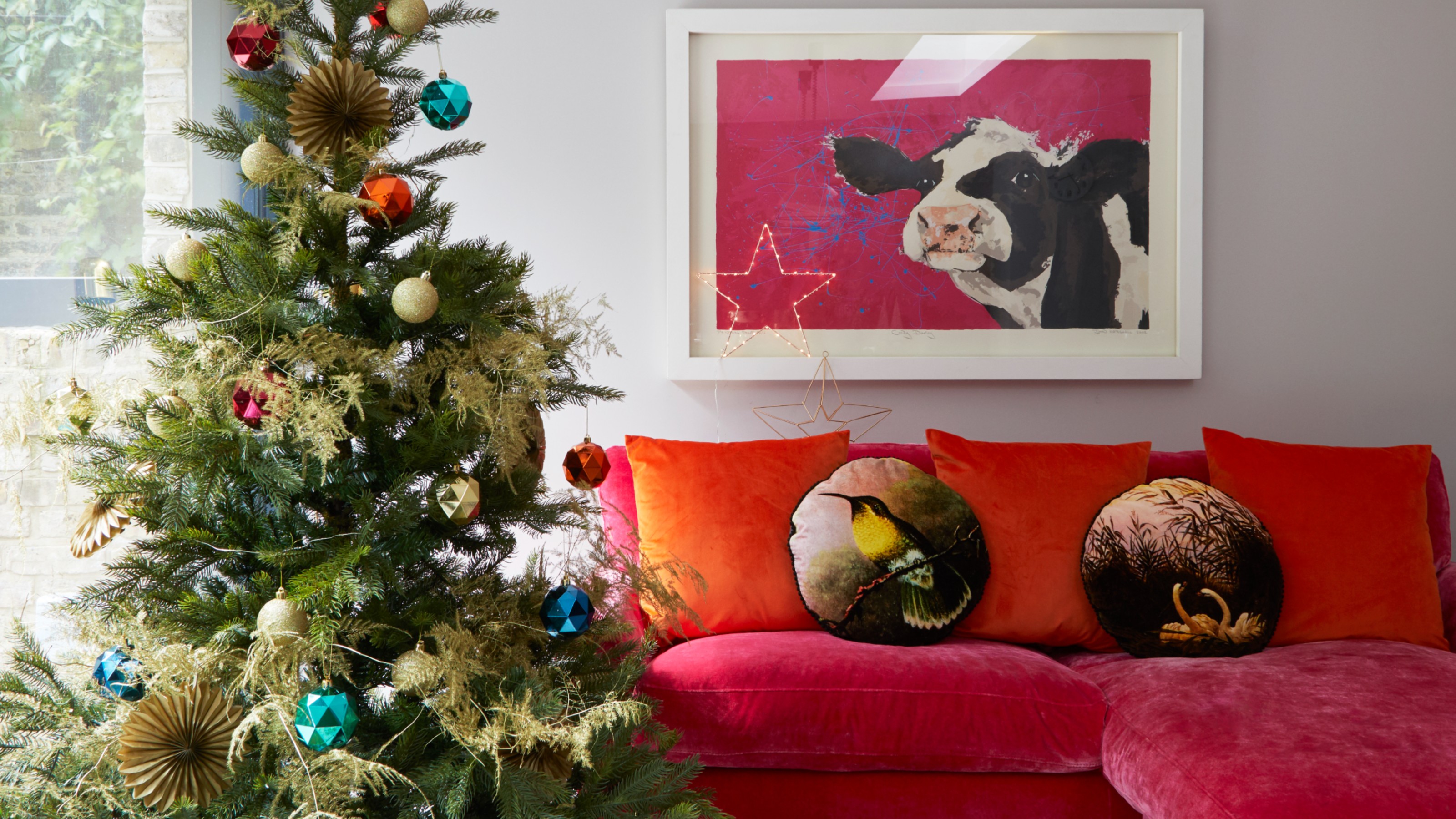A living room with a Christmas tree made look fuller with contrasting foliage