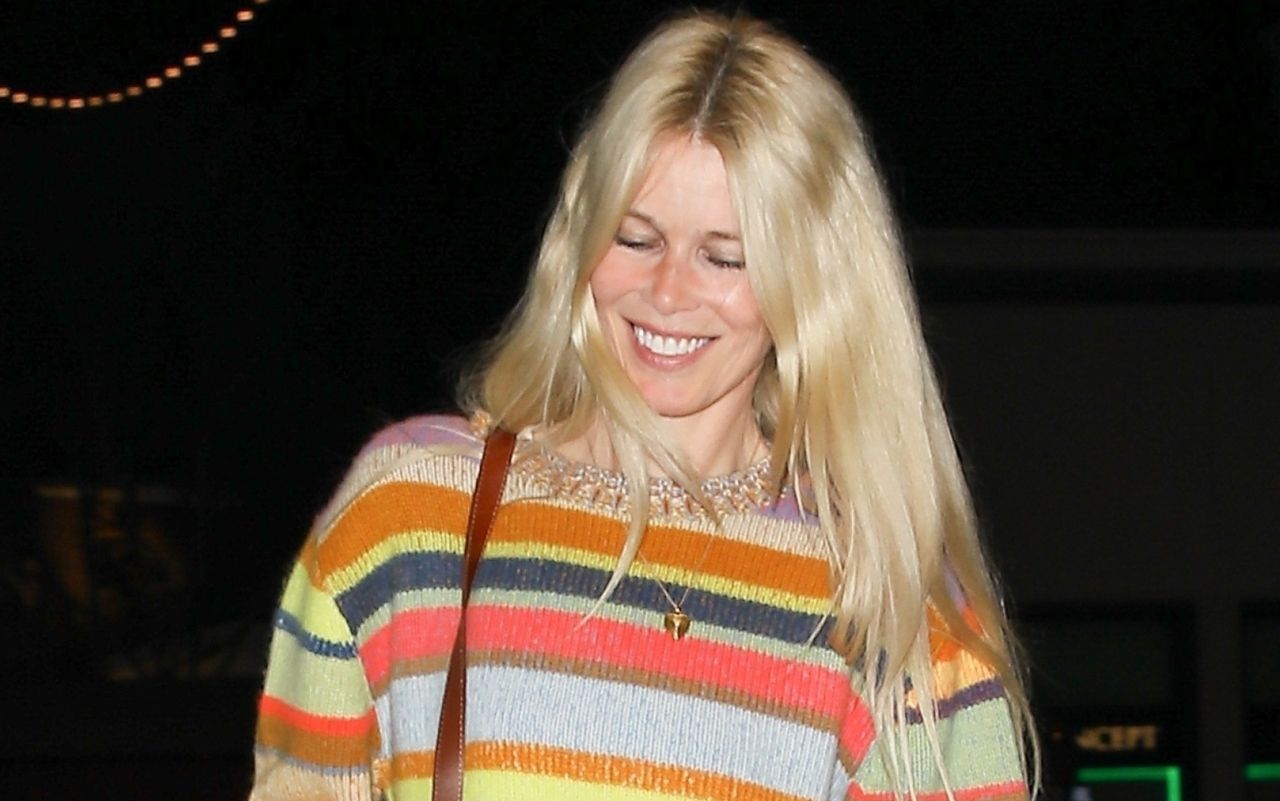 Claudia Schiffer wearing a rainbow stripe sweater and a gold locket in Los Angeles