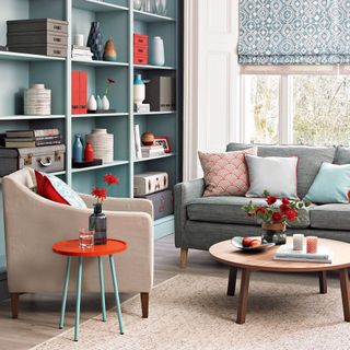 living room with blue sofa and open shelve