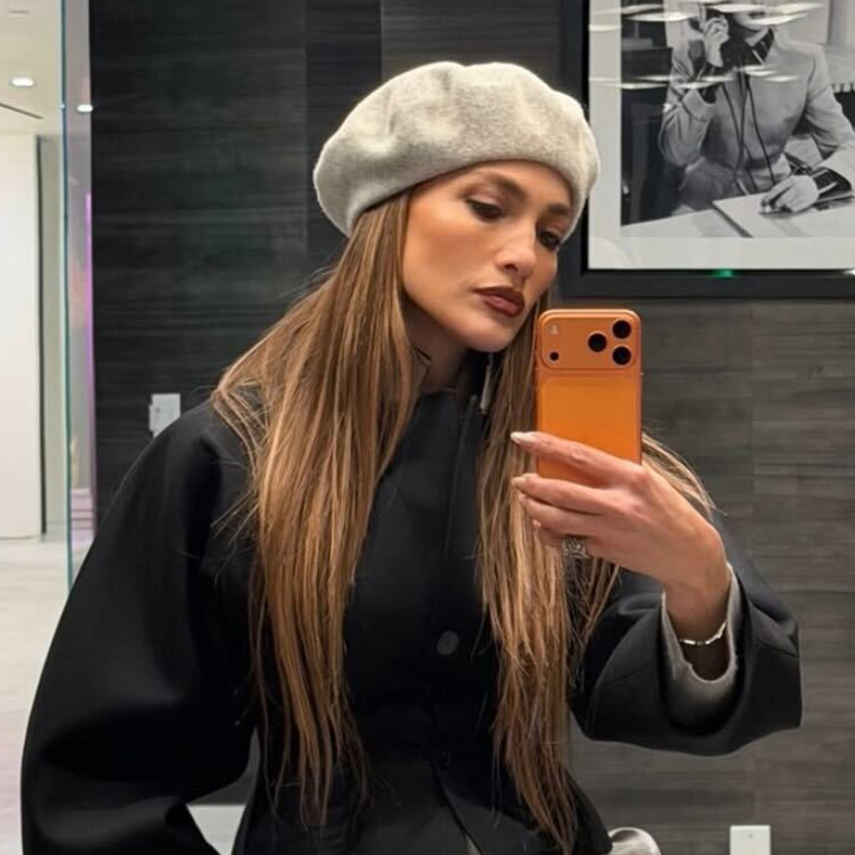 J.lo wears a gray beret and a black top.