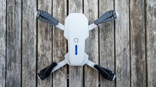 Cheap 4K drone on a table opened into flying position