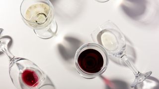 Overhead view of wine glasses and shadows on a white table