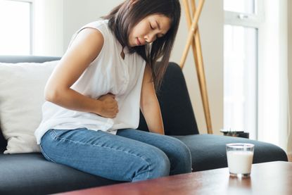 Endometriosis symptoms: a Young Woman Suffering Stomach At Home