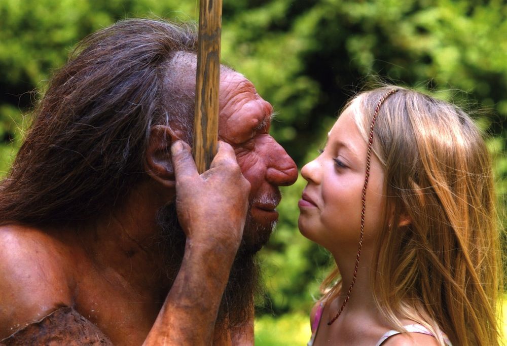 Neanderthal statue with modern human