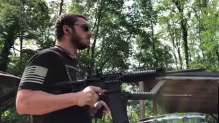 Man playing Slipknot using a gun