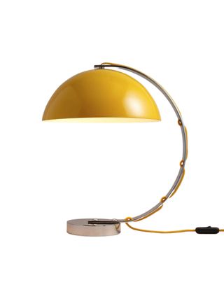 A retro-inspired yellow desk light features a semi-circular arm finished with a semi-circular lamp shade.