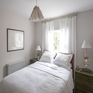 white sheer curtains in a room with white bedding and white walls
