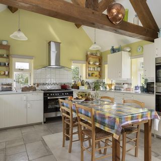 kitchen with wooden beams, tiled floor and wooden table