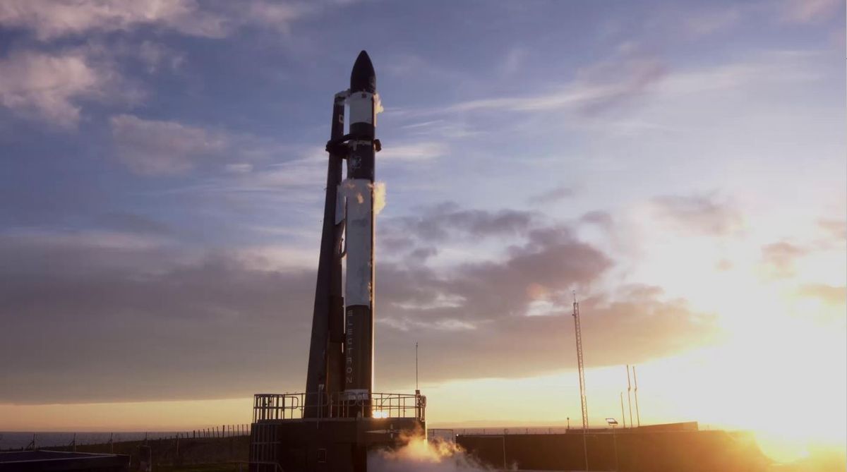 A Rocket Lab Electron booster stands on the pad in New Zealand ahead of the planned Jan. 16 launch of the &quot;Another Leaves the Crust&quot; mission.