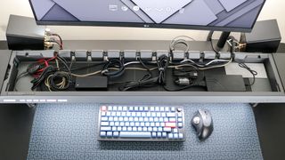 An overhead view of the Hexcal Studio's cord storage chamber with cables and AC adapters inside