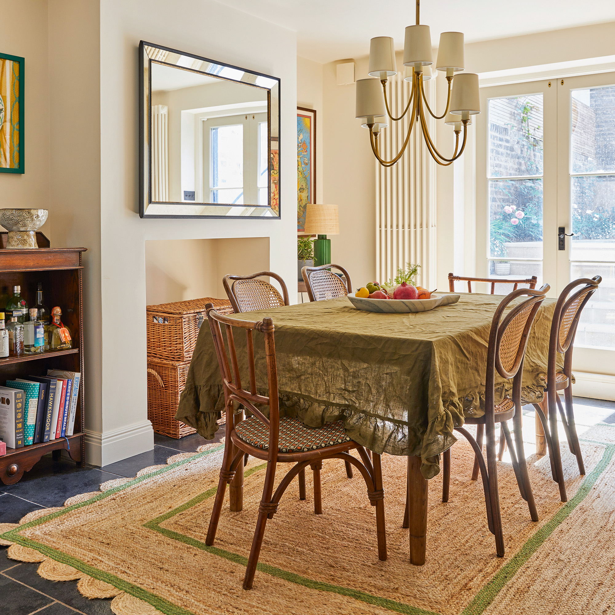 dining area with traditional-style wood table and chairs on a natural rug with multi-arm chandelier