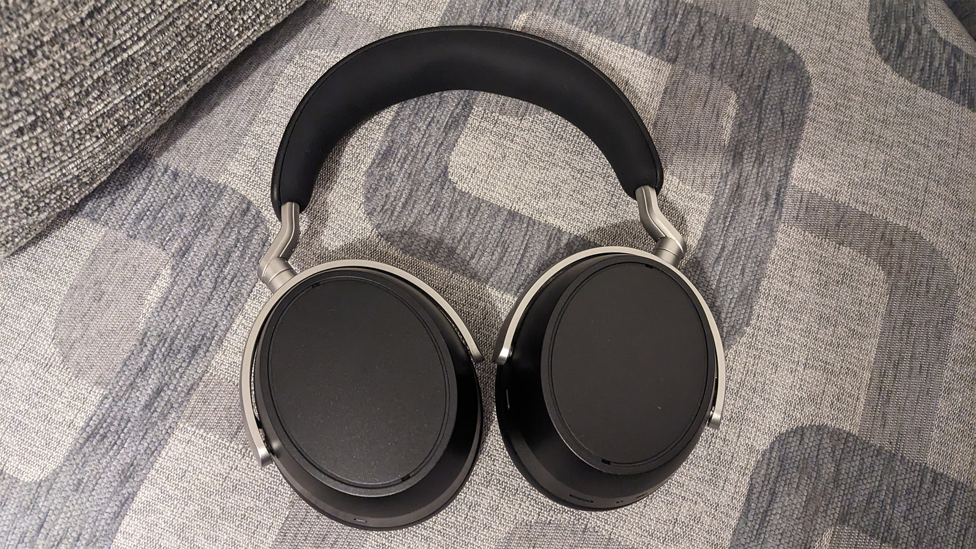 Sennheiser HDB 630 over-ear headphones fac down on patterned fabric sofa