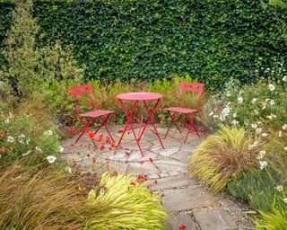 Patio seating area surrounded by ornamental grass