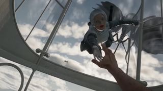 A screenshot of the Atomic Heart release trailer showing a mannequin-like woman being pulled out of a window by a drone.