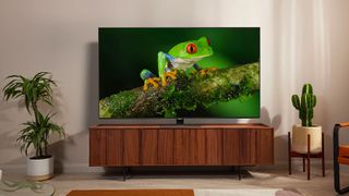 A product shot of the Samsung Q80B TV on a cabinet in a bright living space