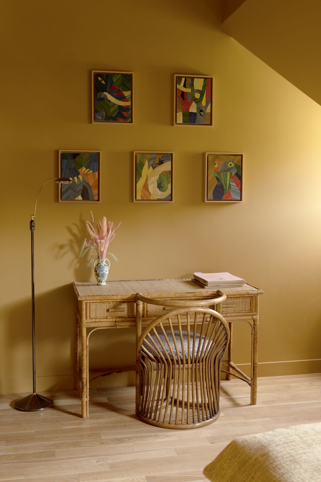 A whimsically designed hotel boasts richly layered interiors characterized by hand-drawn, fantastical mural motifs, earthy and pastel shades, and shapely furniture.