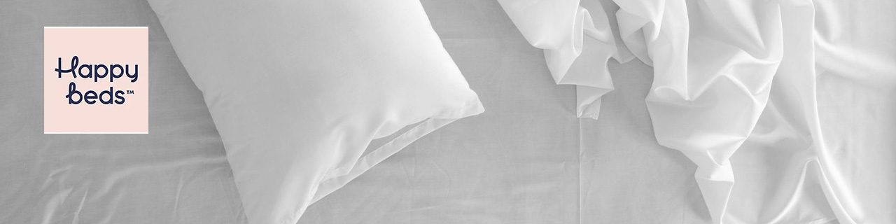 Happy Beds logo top left on a wide image of a bed with white bedding, pillow and sheets