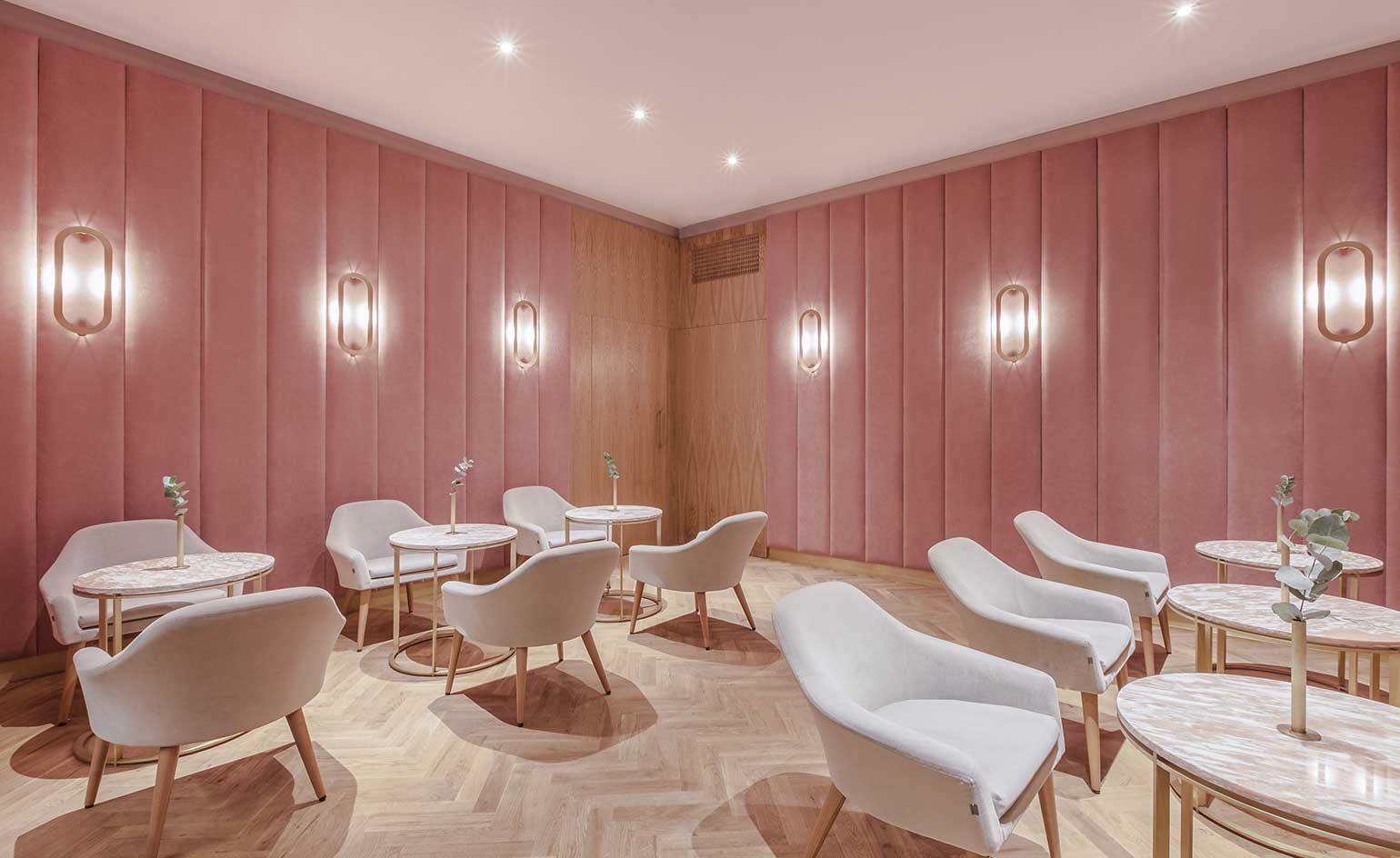Chairs & tables in pink walled room