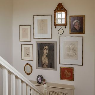 white themed stairway with photos