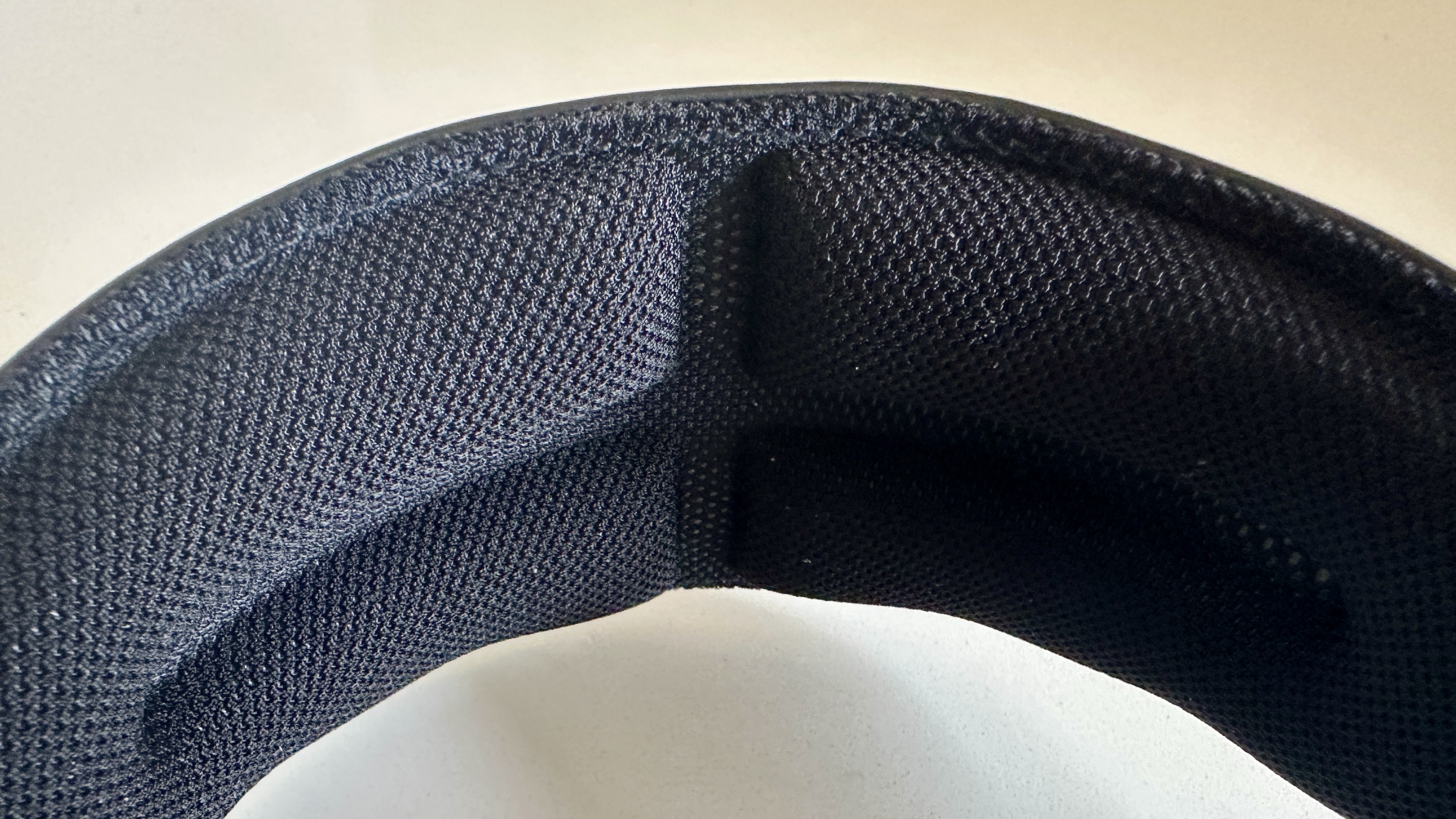 Meze Audio Strada headphones with wooden ear cups, in close-up and with their case and cables visible, on a white table