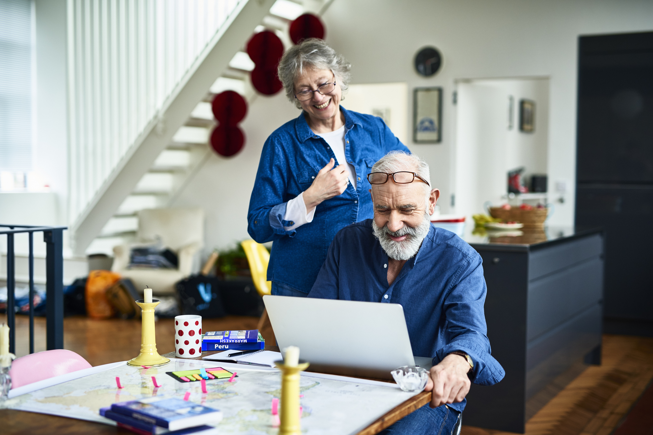 Retired couple smiling while checking their state pension payments