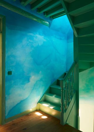 Painted green staircase and blue walls
