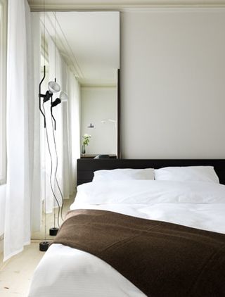 Bedroom with white cushion and bedlinen