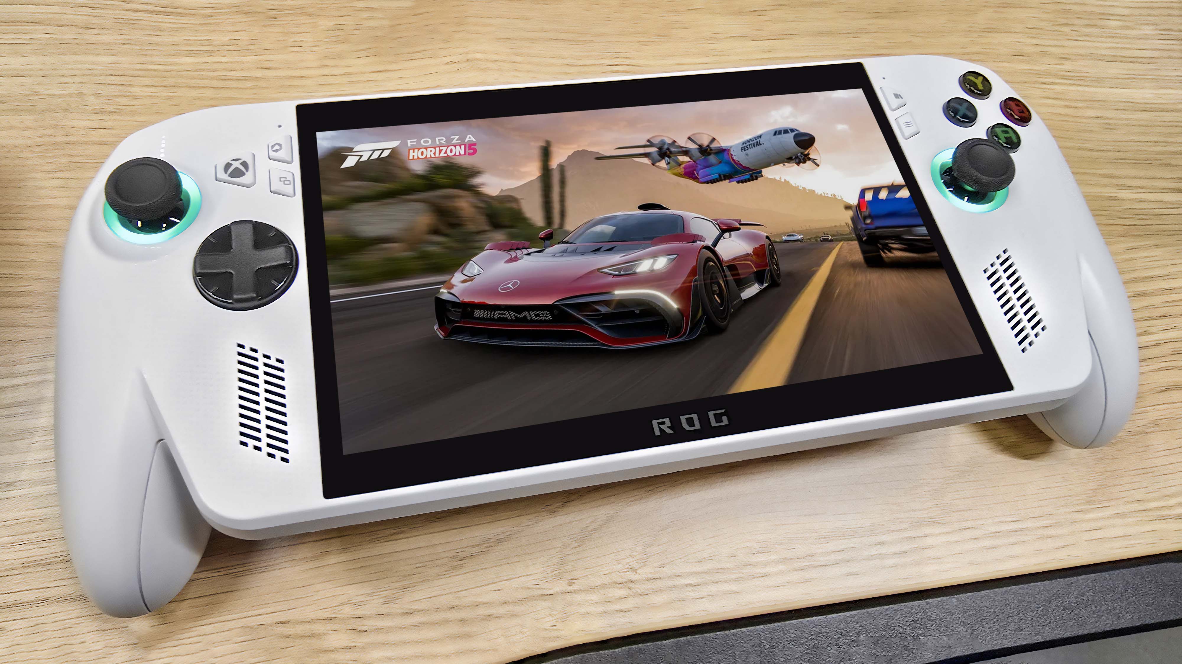ROG Xbox Ally on a wooden table displaying a screenshot from Forza Horizon 5.