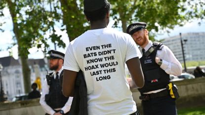 A man attends an anti-lockdown protest outside Westminster