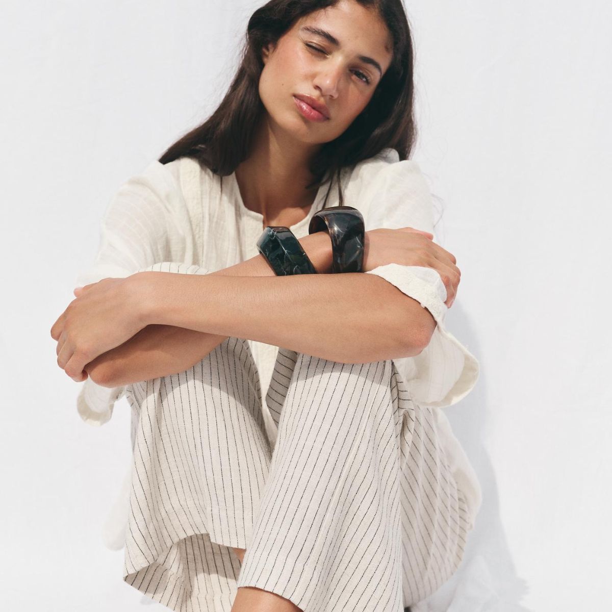 Woman wears white t-shirt, white striped trousers