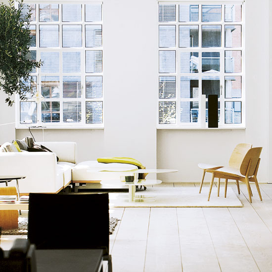 living room with white wall and wooden flooring with papa chairs