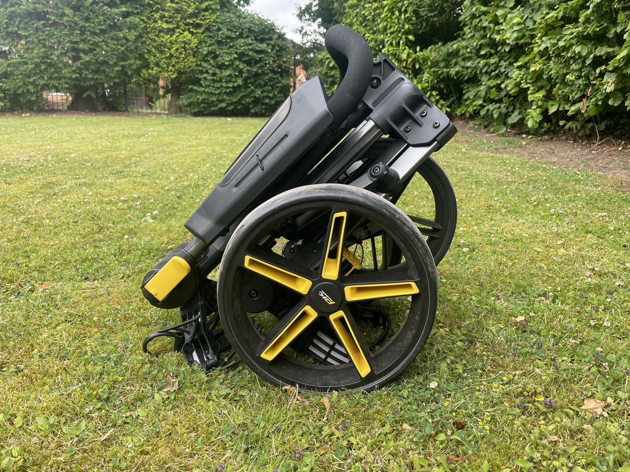 The PowaKaddy Micra push cart folded up into its smallest state