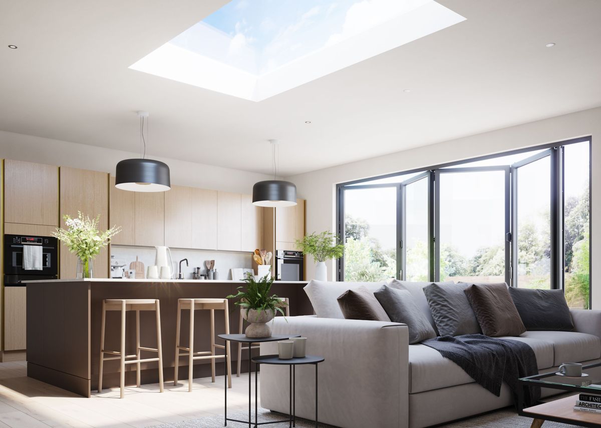 A kitchen with a roof lighting and bifold doors