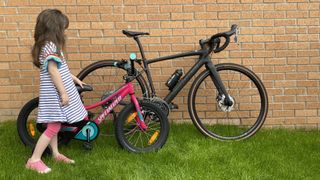 Child standing next to Specialized bikes