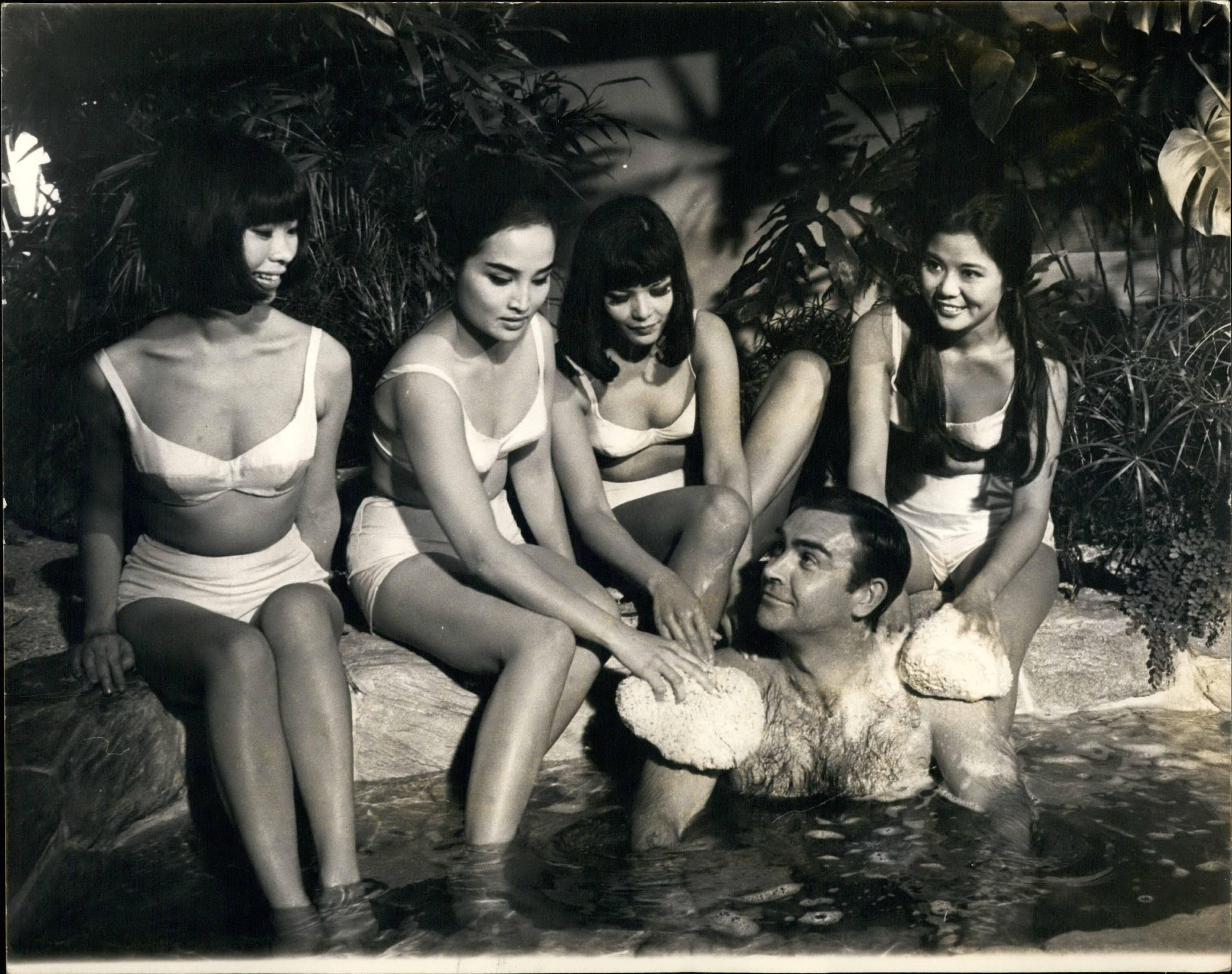 Sean Connery as James Bond with women in bikinis