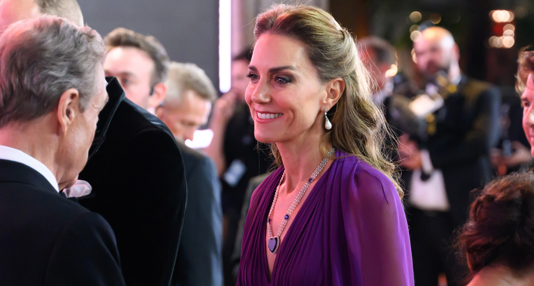 Princess Kate wearing a purple gown and pearl necklace