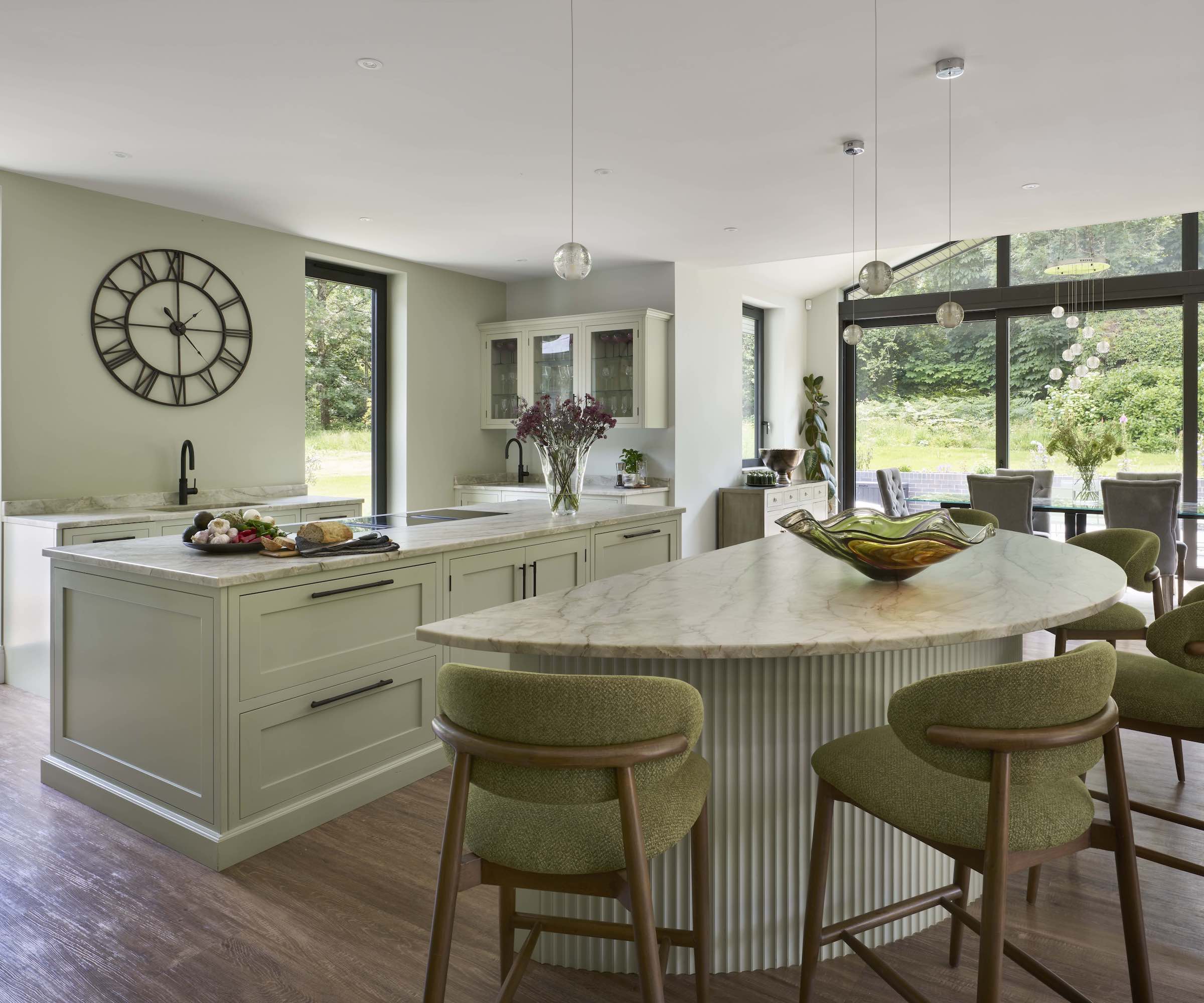 kitchen with two islands and green stools